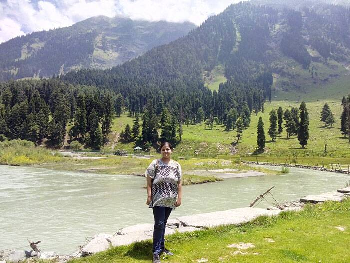 Chandanwari in pahalgam. A woman standing on the bank of a river.